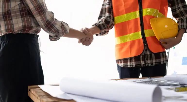 Architect And Engineer Construction Workers Shaking Hands While Working For Teamwork After Finish An Agreement In The Office Construction Site