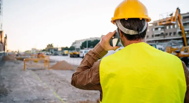 Unrecognizable Foreman Speaking On Smartphone
