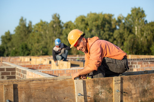 Construction worker wearing a yellow hard hat on an active job site.